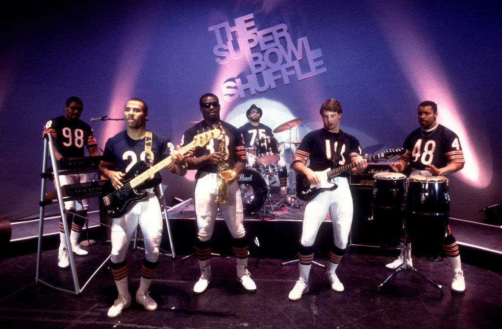 Members of the Chicago Bears onstage holding instruments