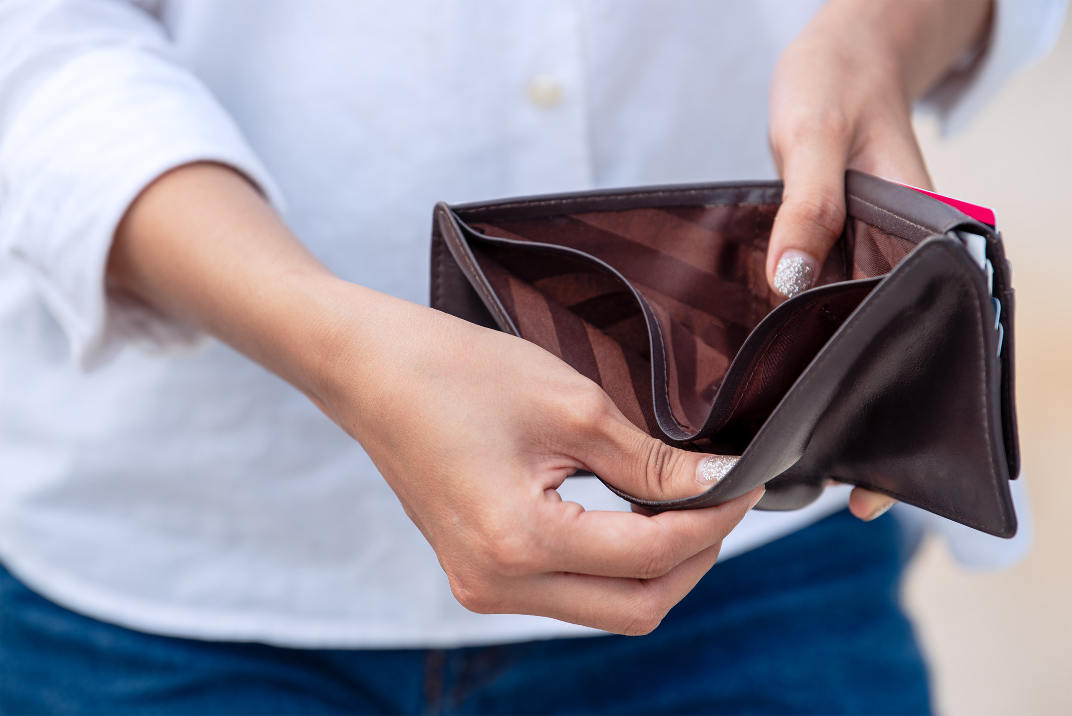 Person holding an empty wallet