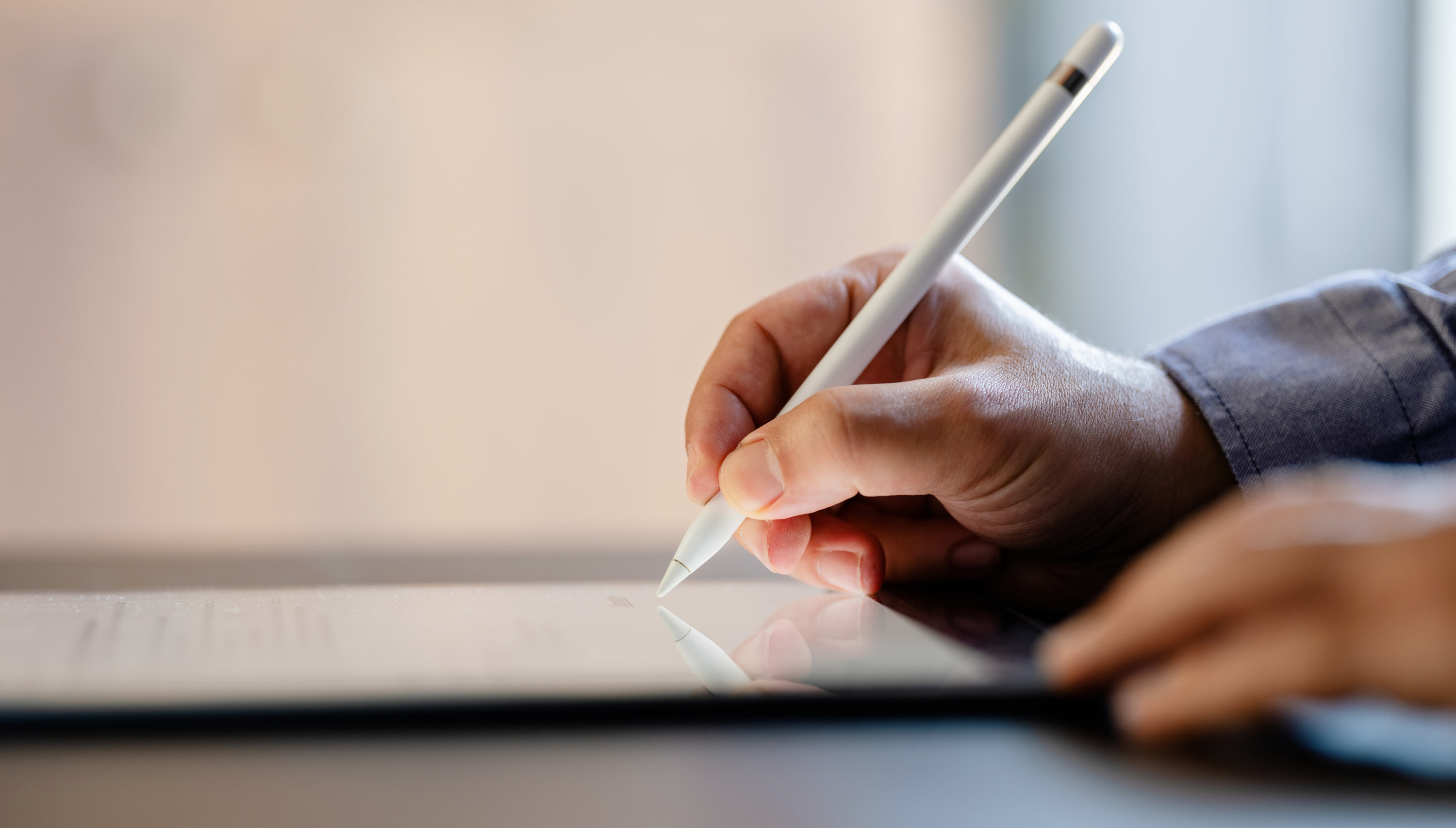 Person signing a contract by a tablet