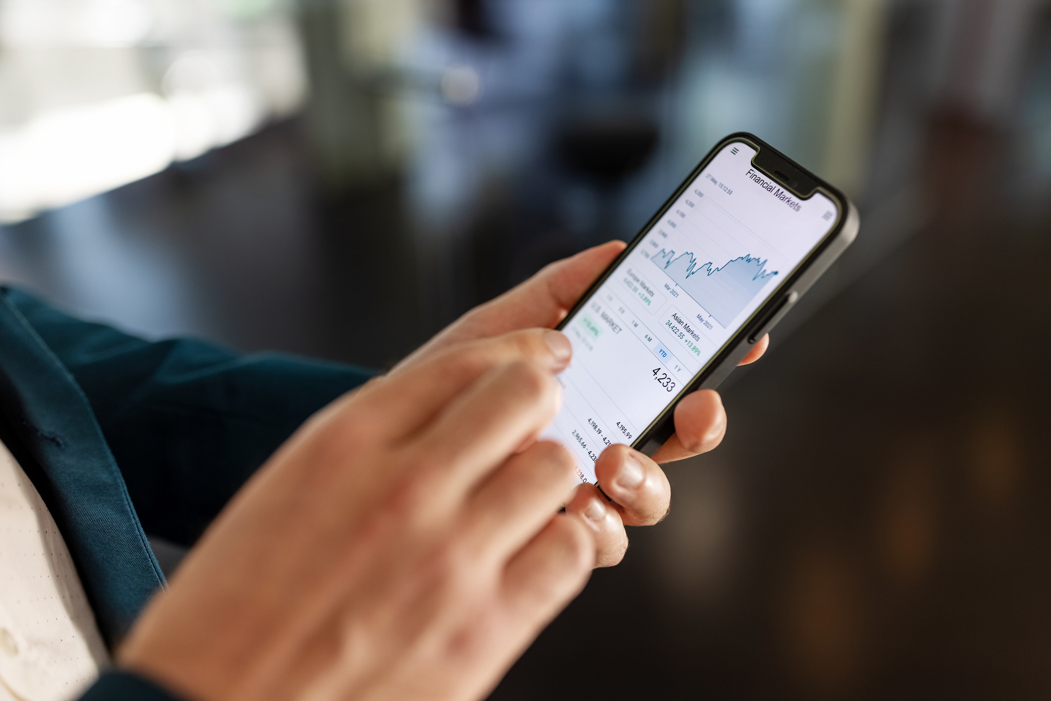 Person looking at financial numbers on a cellphone