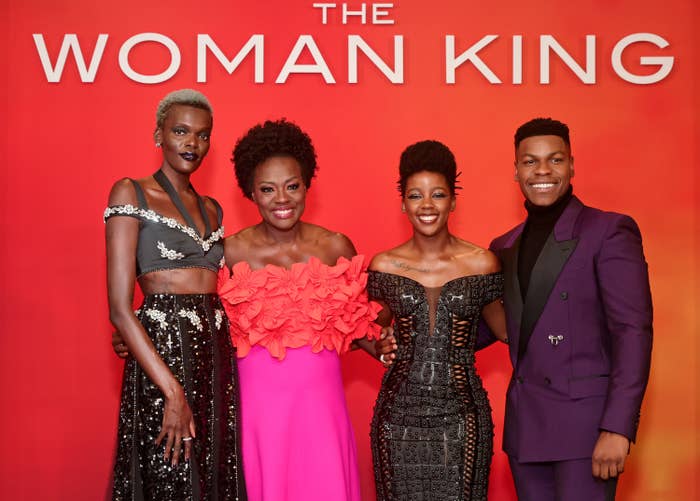 The cast of The Woman King arm in arm