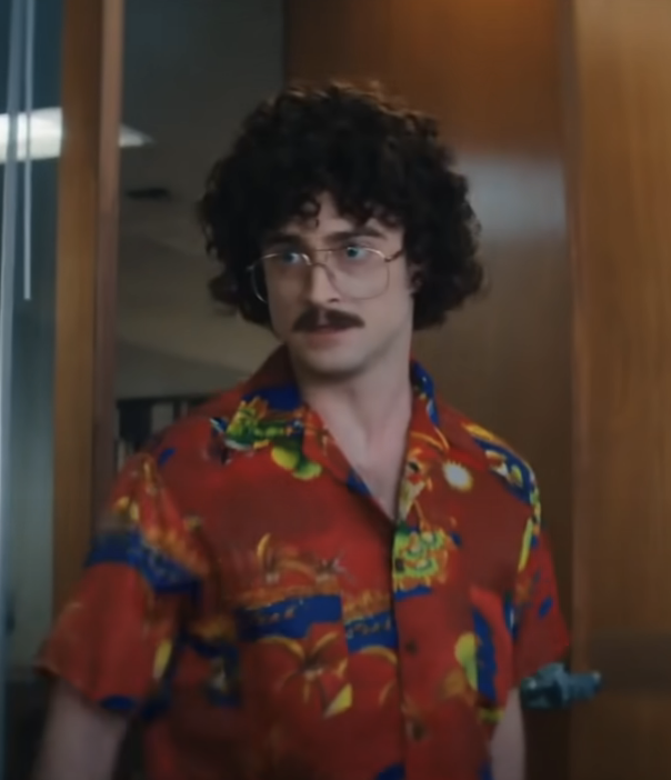 daniel in a hawaiin shirt, glasses and curly hair