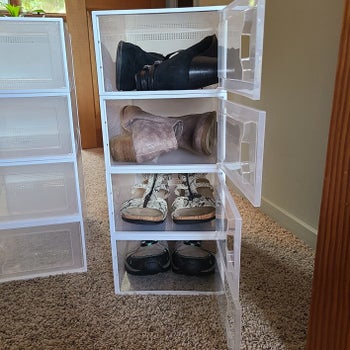 Storage boxes opened to reveal shoes inside