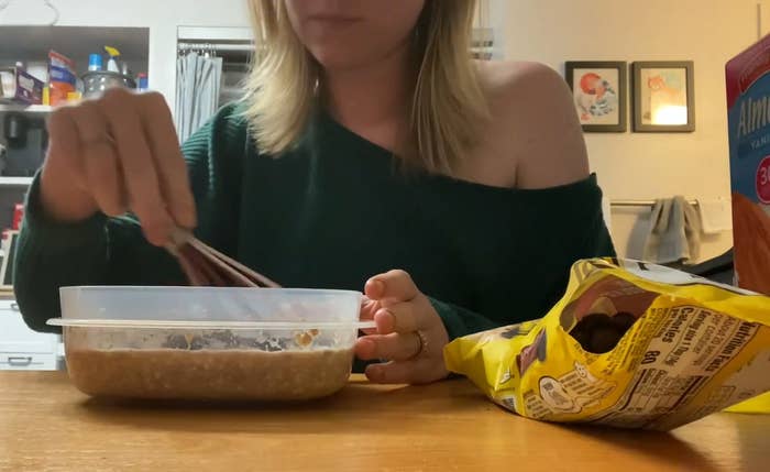 student mixing overnight oats in their dorm room