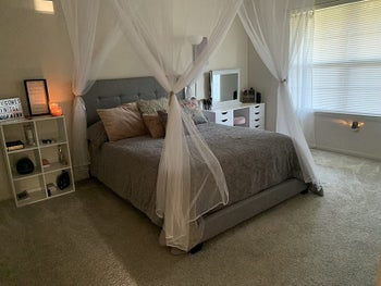 Reviewer photo with a white canopy above their gray bed