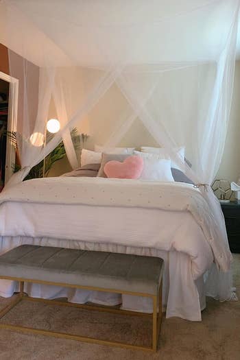 a reviewer photo of the white canopy over a bed