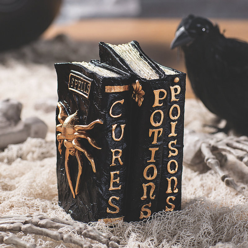 the book set in black that says &quot;curses, potions, and poisons&quot; on the spines