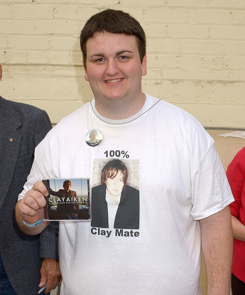 A man holding a Clay Aiken CD