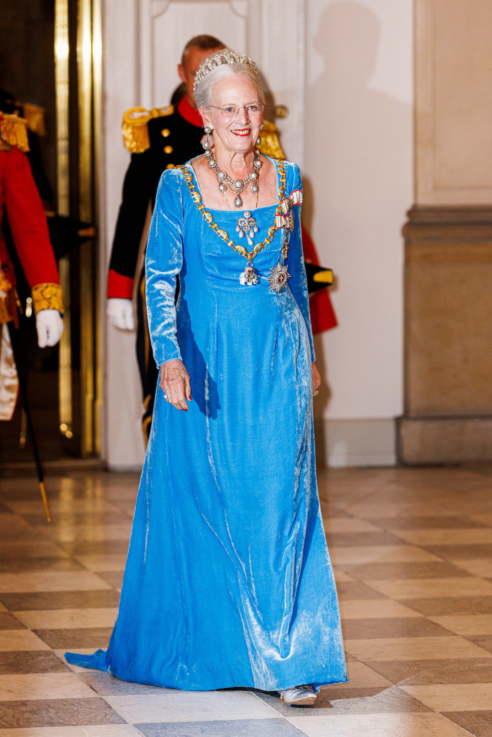 the queen smiling and walking