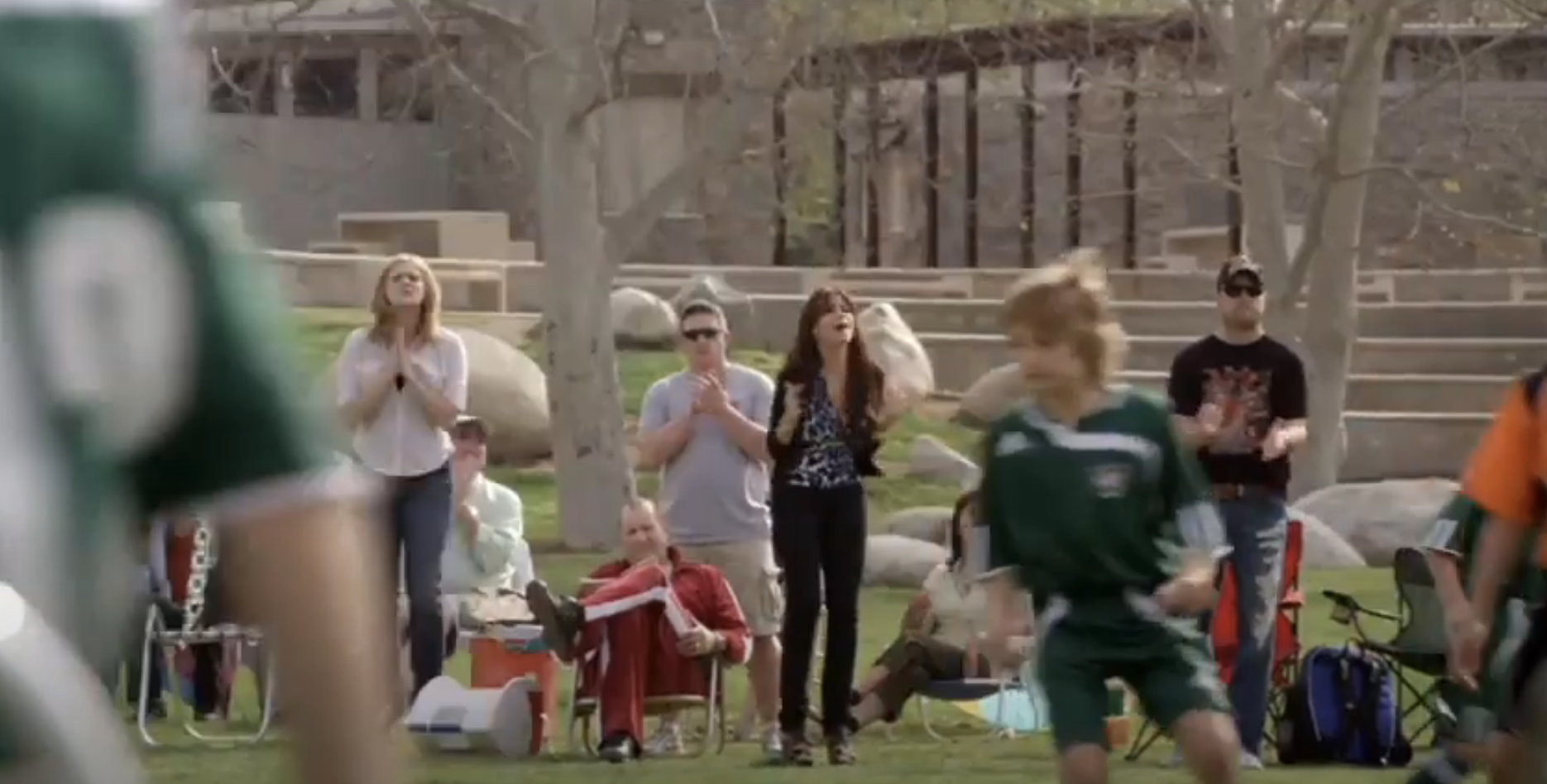 parents cheering their kids on at a soccer game