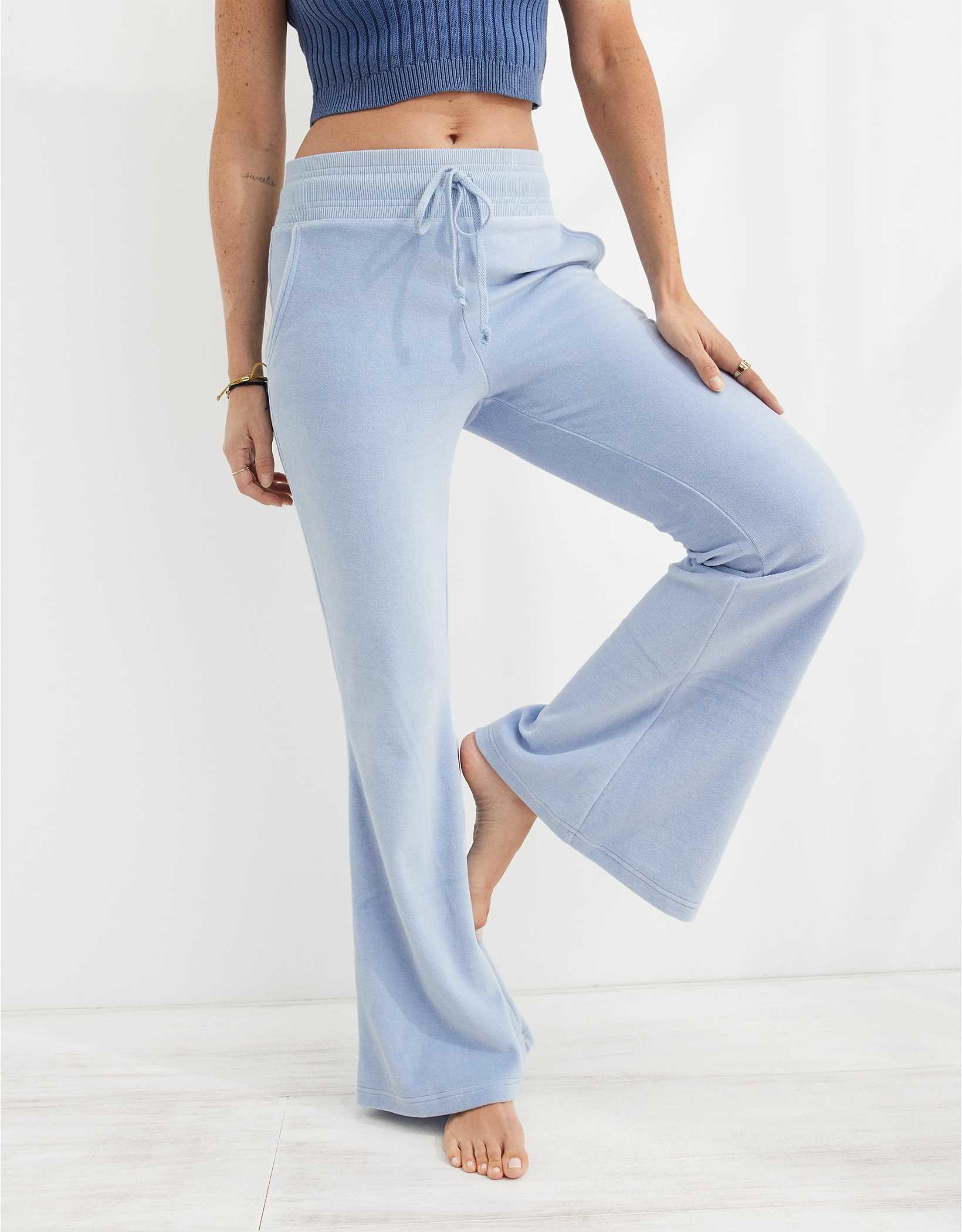 model in light blue flare velour sweat pants with a drawstring