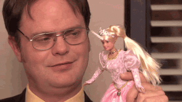 Dwight Schrute playing with a Barbie doll