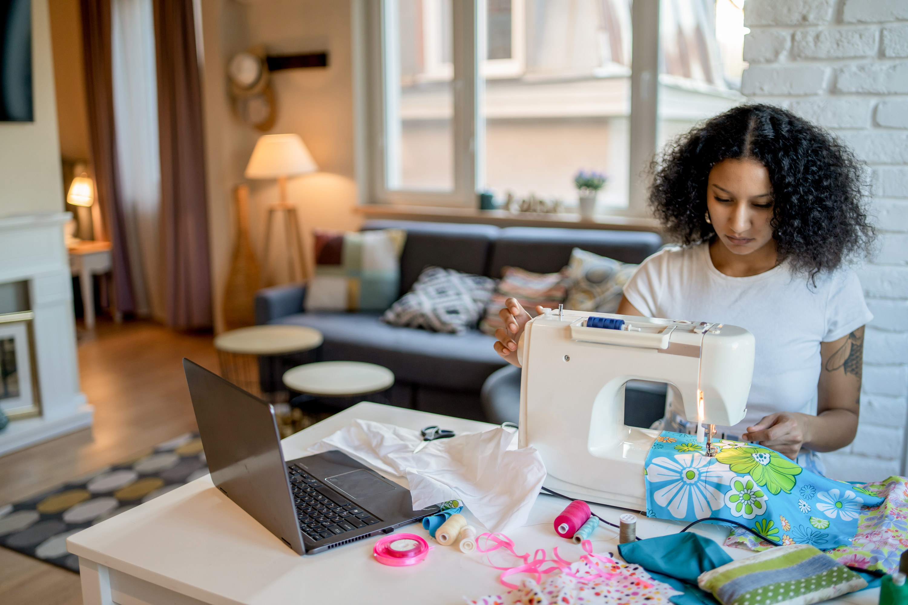 A seamstress is creating homemade items to sell on her online business