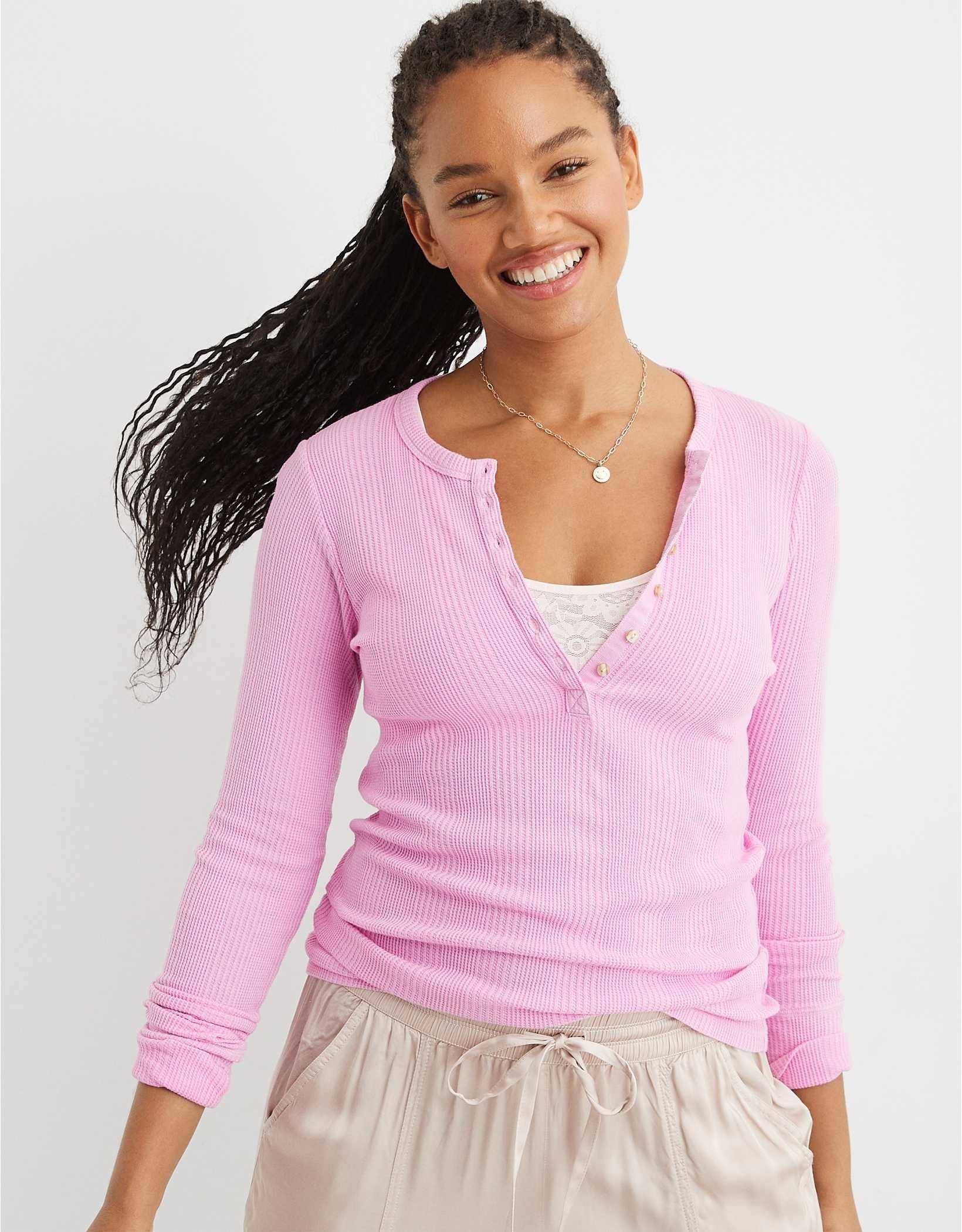 model in pink ribbed long sleeve henley
