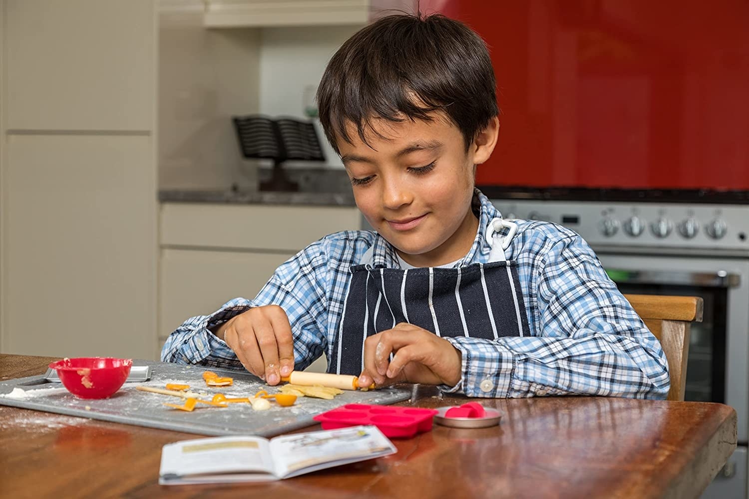 child playing with the mini baking set rolling out dough