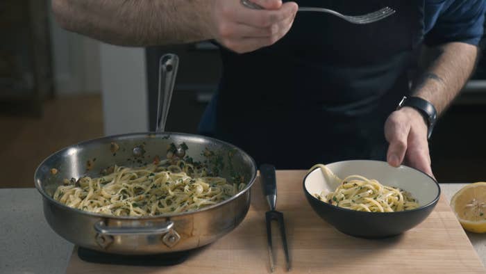 serving Pasta Aglio e Olio into a bowl