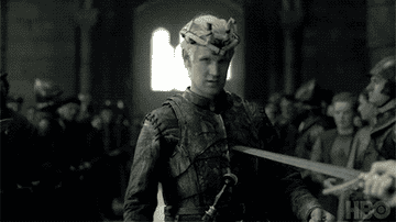 GIF of Daemon holding a sword up and telling Viserys to add it to the chair