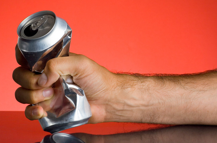 Man crushing a soda can in his hand