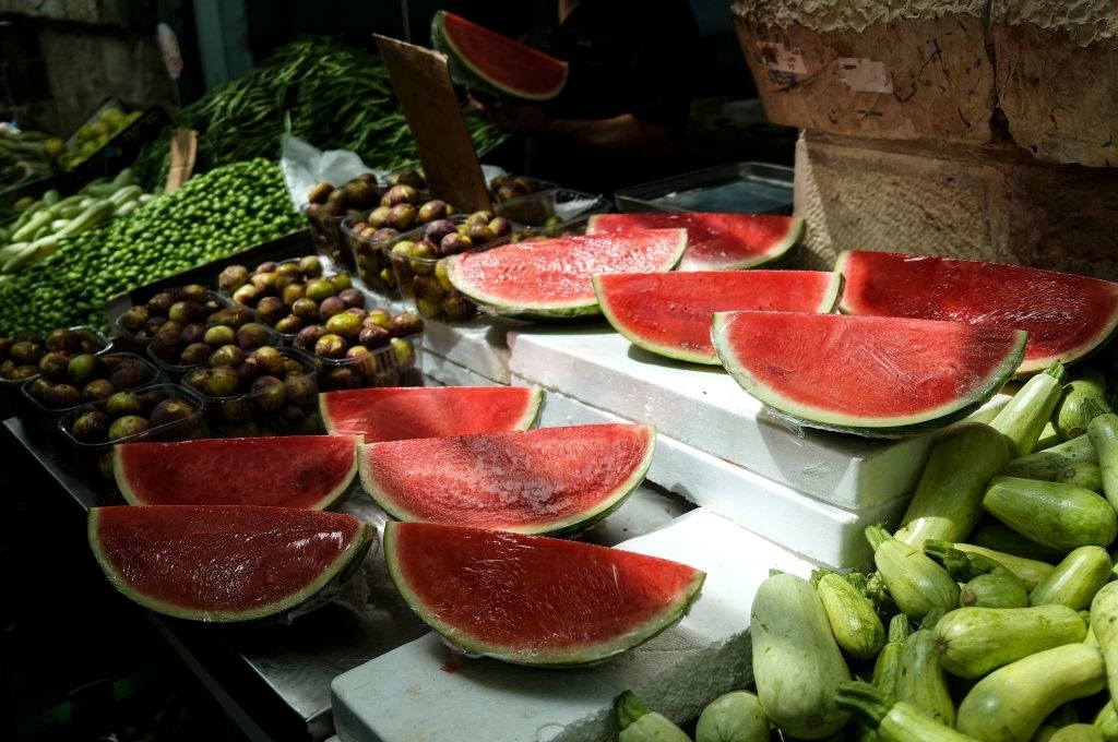 Watermelon wedges for sale at a farm stand