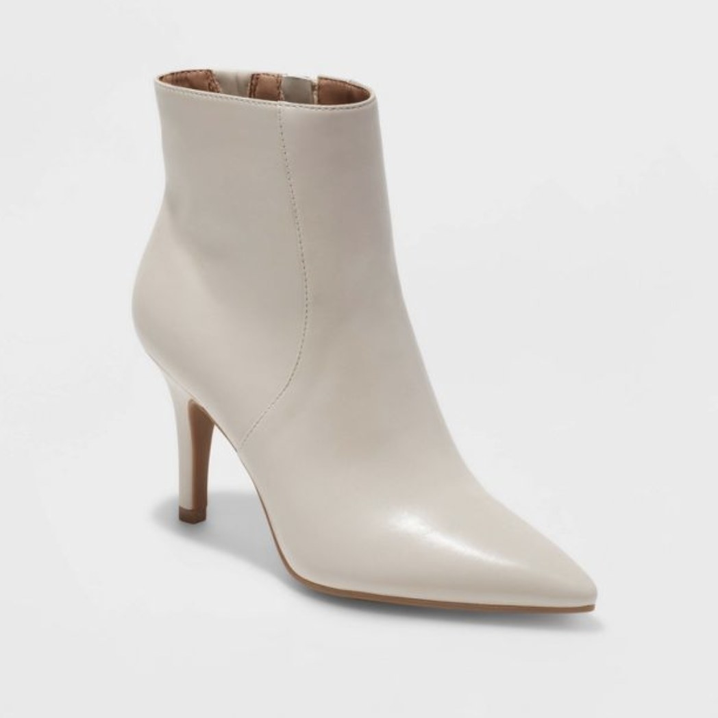 The pearlescent boots have a thin heel and point front toe