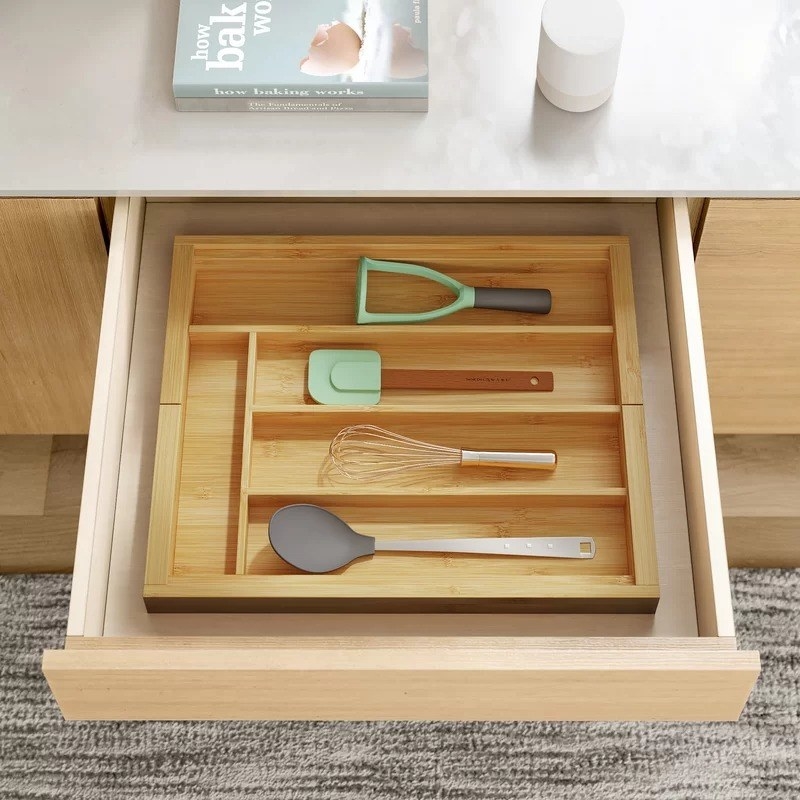 the organizer in a drawer with utensils in it