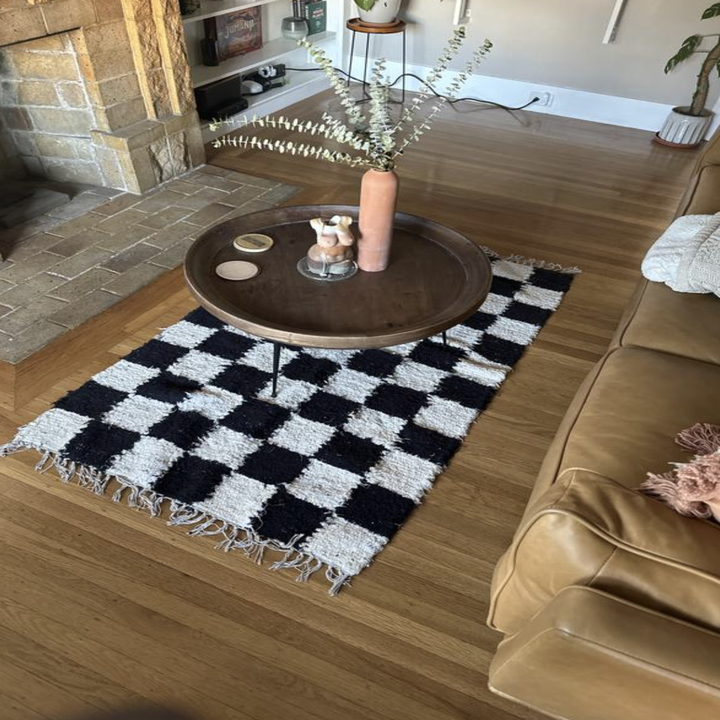 the black and white checkered rug under a table