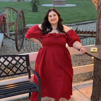 Another reviewer wearing burgundy dress off the shoulder