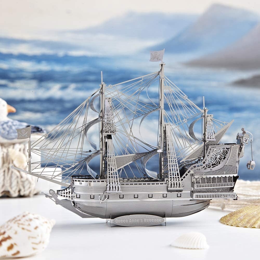 the pirate ship puzzle on a table surrounded by sea shells