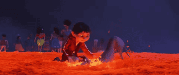 gif from the movie coco of a a dog throwing leafs at a boy
