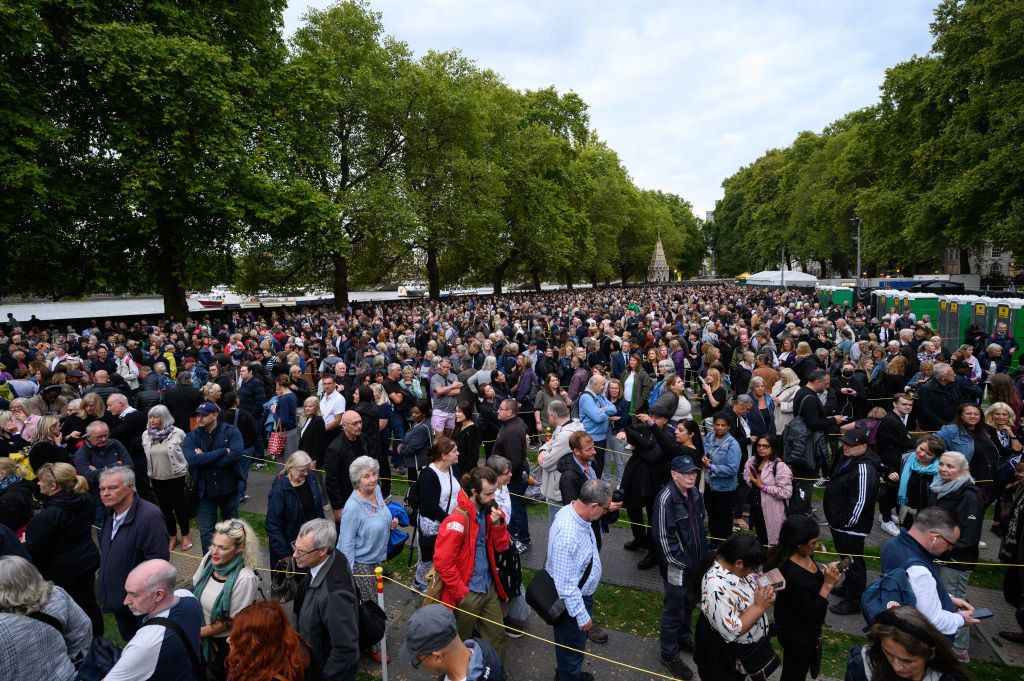 Members of the public wait in a queue to pay their respects to Queen Elizabeth II outside the Houses of Parliament 