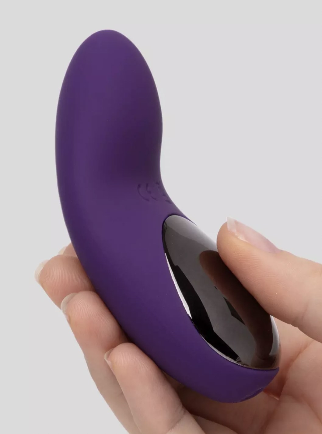 Someone holding the purple vibrator in palm
