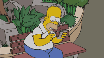 Homer Simpson playing a game on his phone