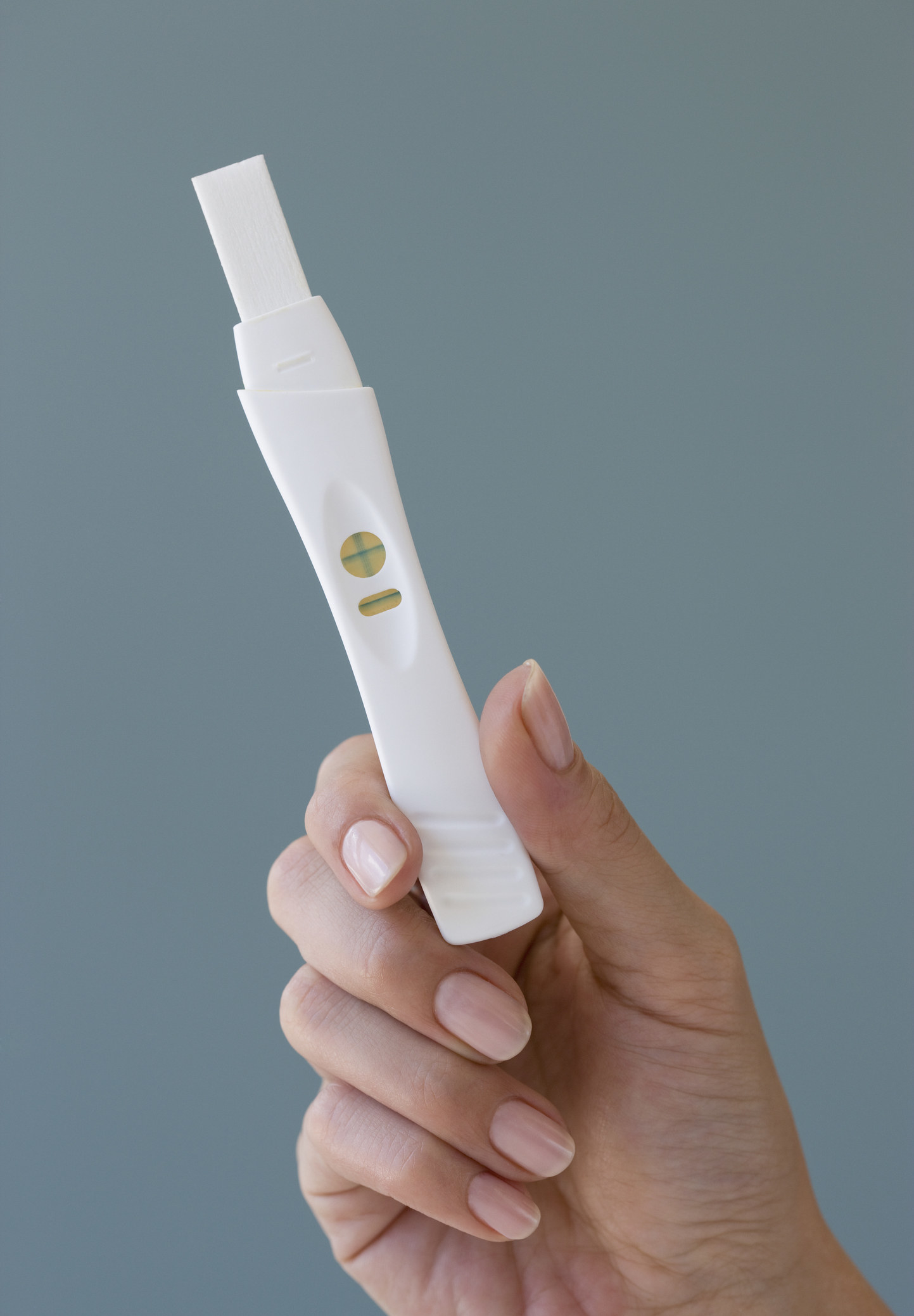 A person holding a pregnancy test