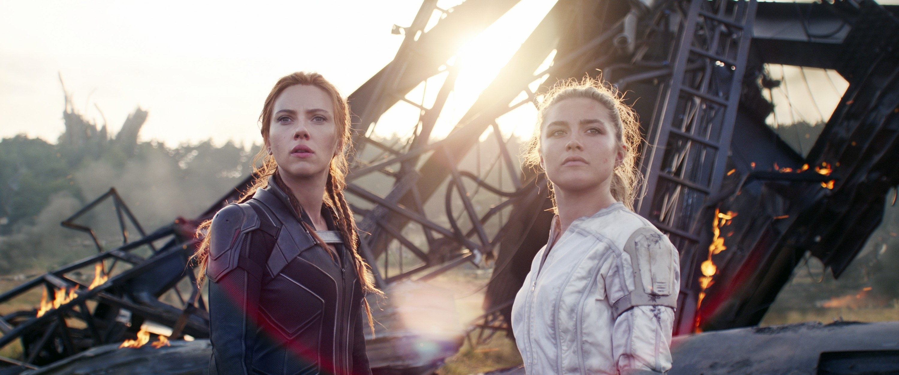 Scarlett Johansson and Florence Pugh stand beside some wreckage