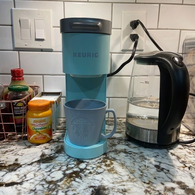 A blue cup in a blue coffee maker