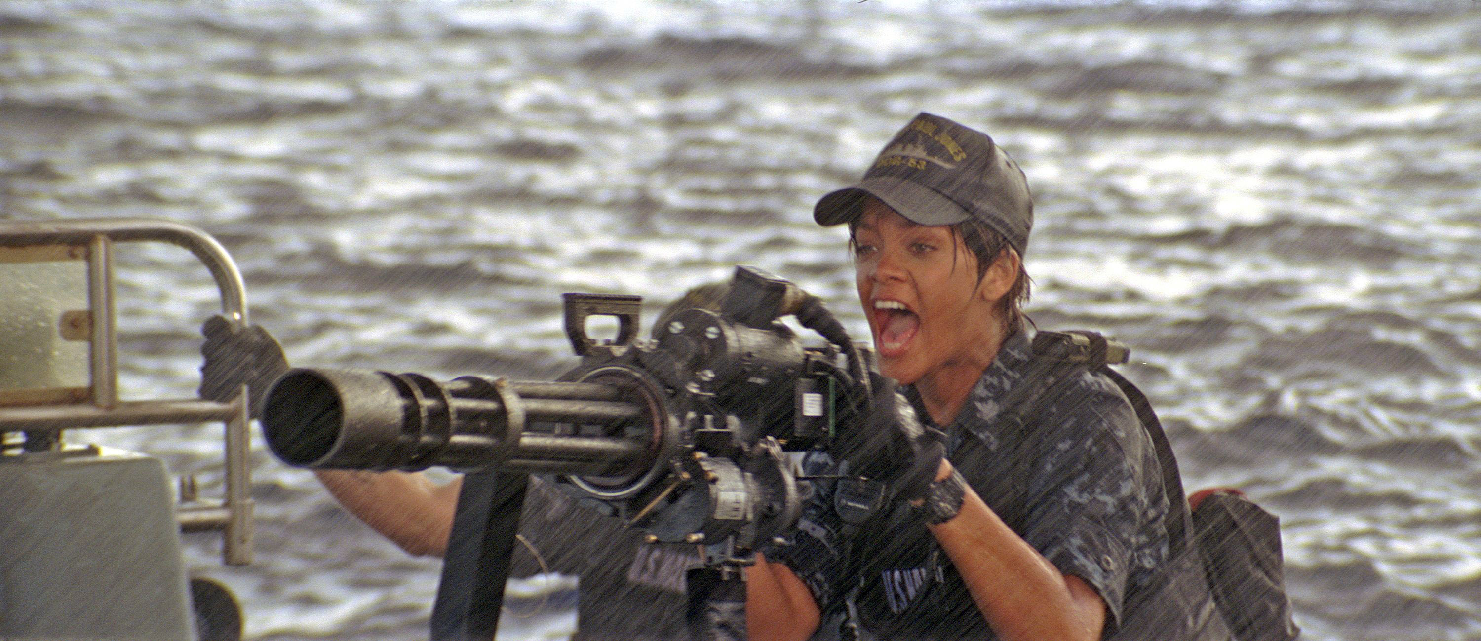 Rihanna aiming a large weapon at sea