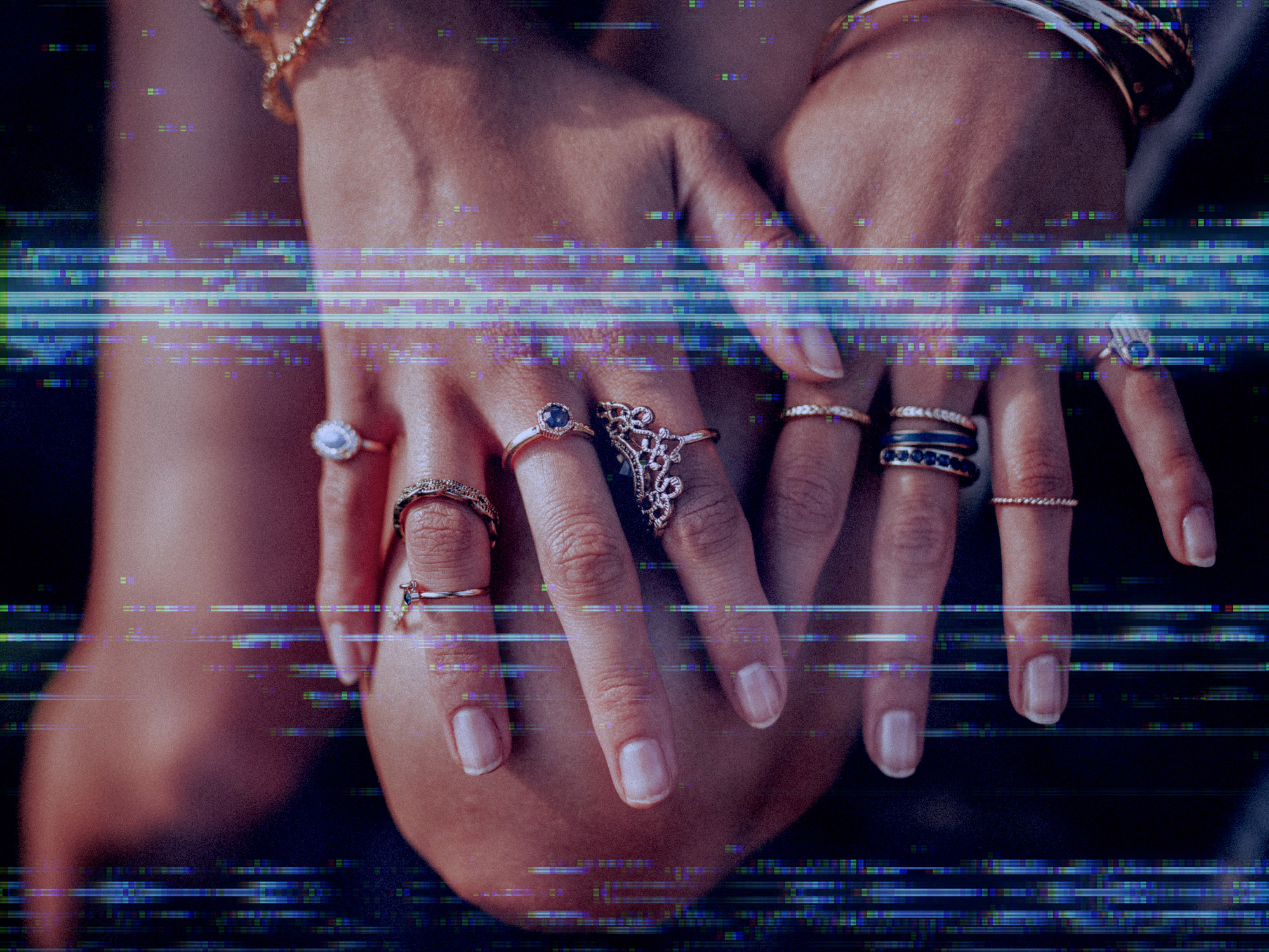 a person&#x27;s hands with rings on it