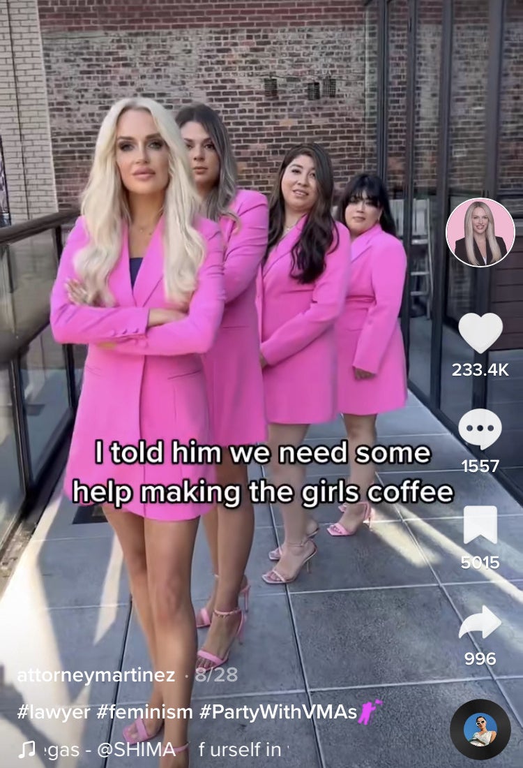 Attorney Martinez and the women who work at her firm all wearing pink and standing in formation