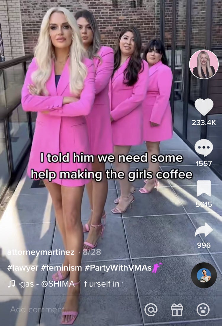 Attorney Martinez and the women who work at her firm all wearing pink and standing in formation