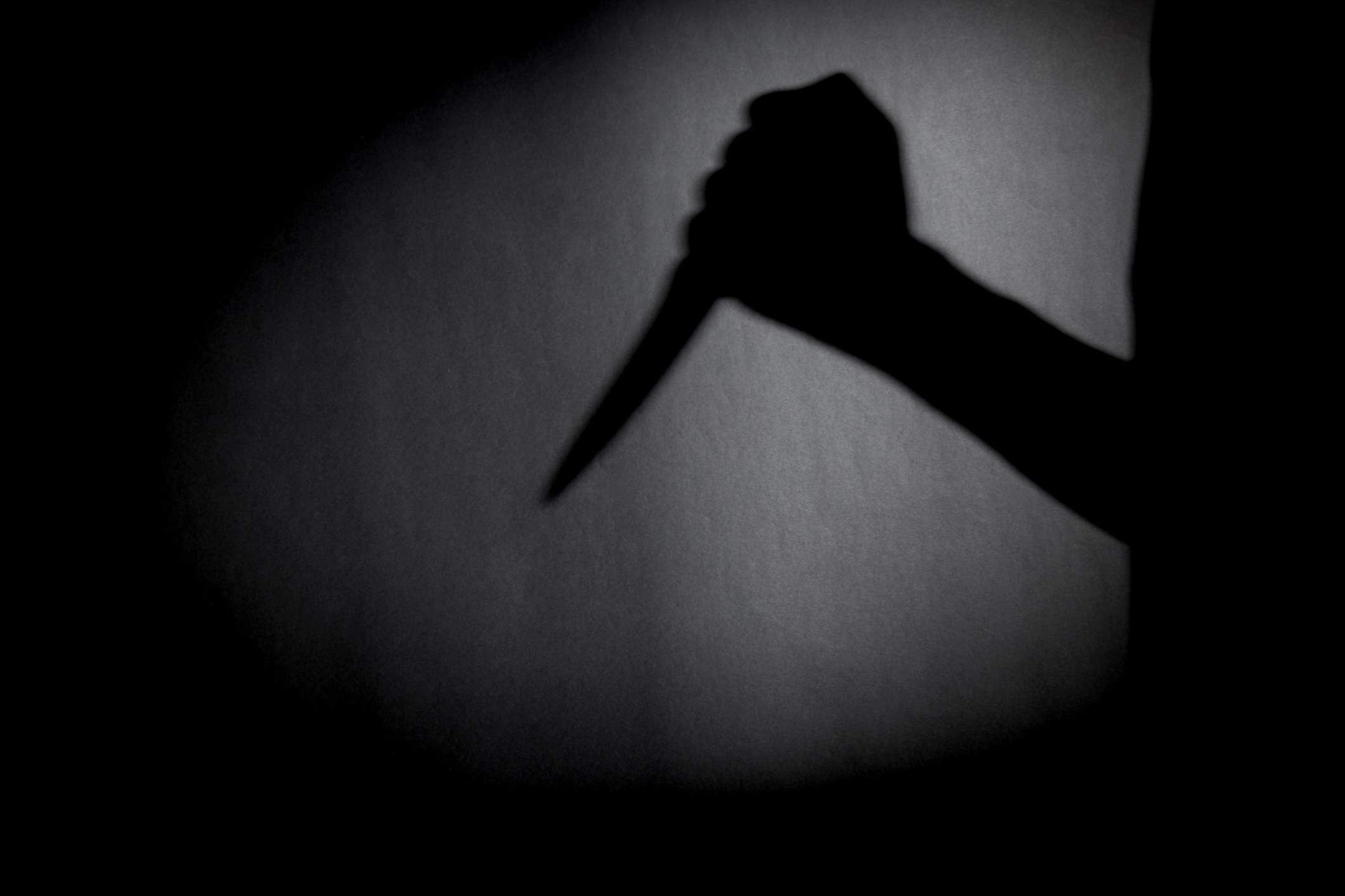 Shadow of someone holding a kitchen knife