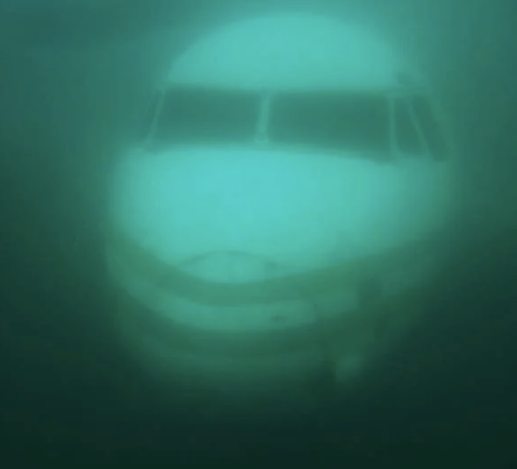 The nose and cockpit of a fully submerged plane