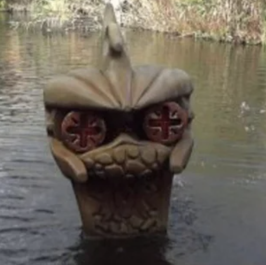 A partially submerged statue with intense-looking eyes