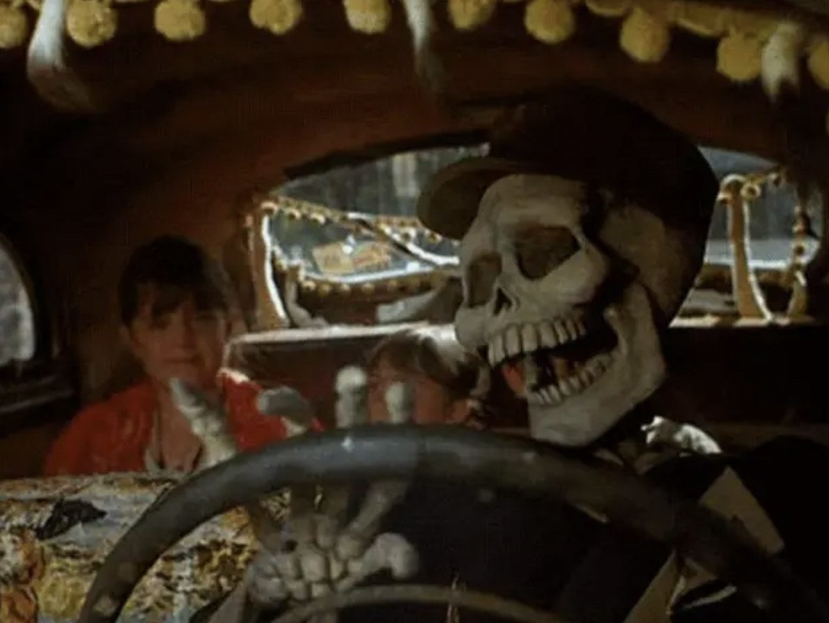 skeleton driving a taxi cab with a girl in the backseat