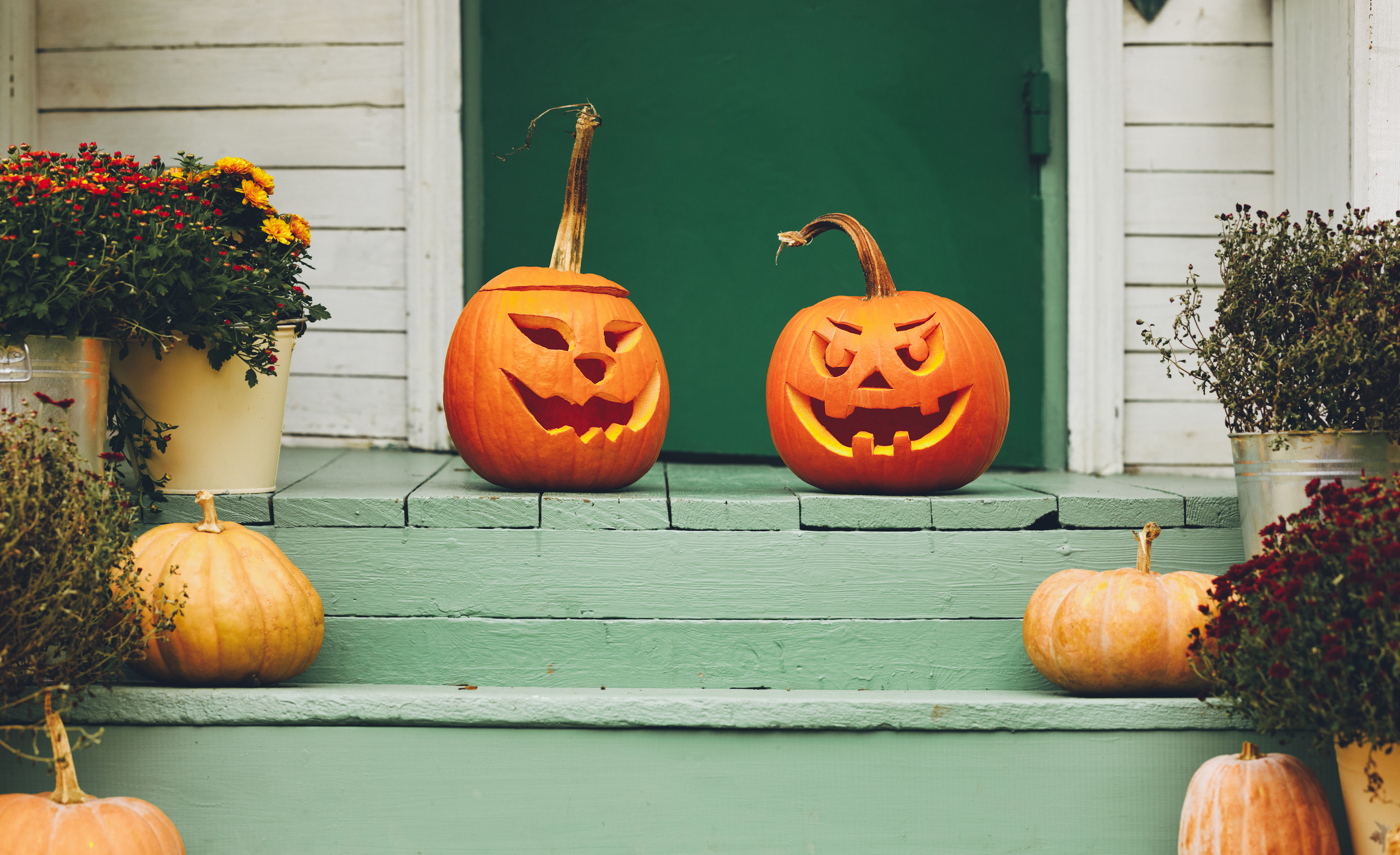 two pumpkins on a stoop