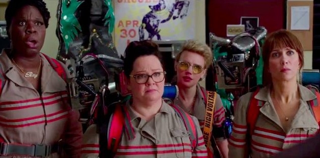 The female ghostbusters stand in a row