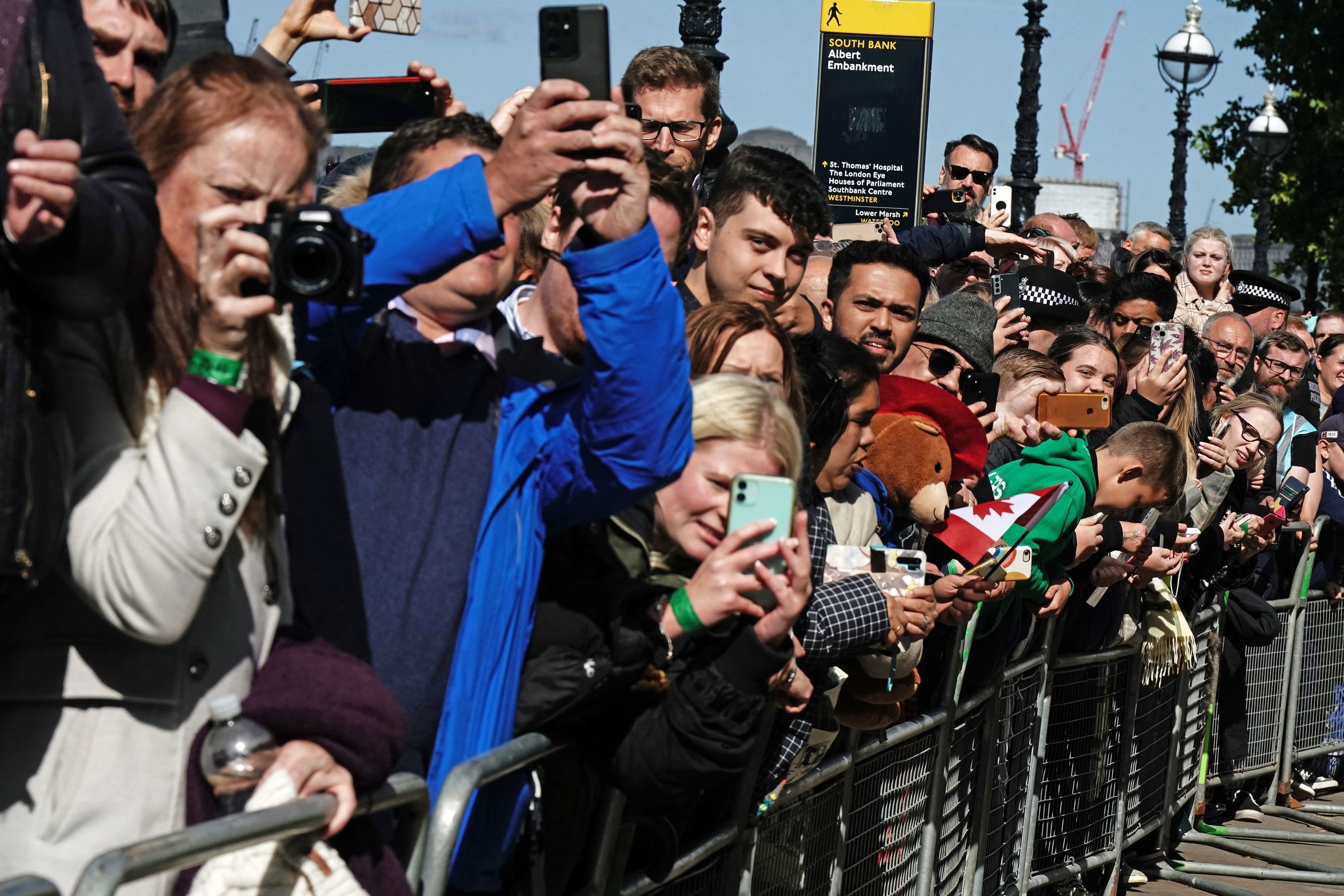 Members of the public try to catch a glimpse of the visiting royal family members