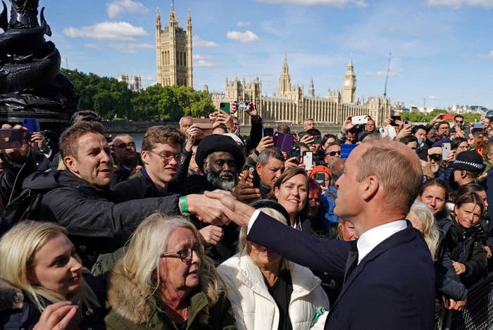 Prince William talks with members of the public waiting in the queue on the South Bank