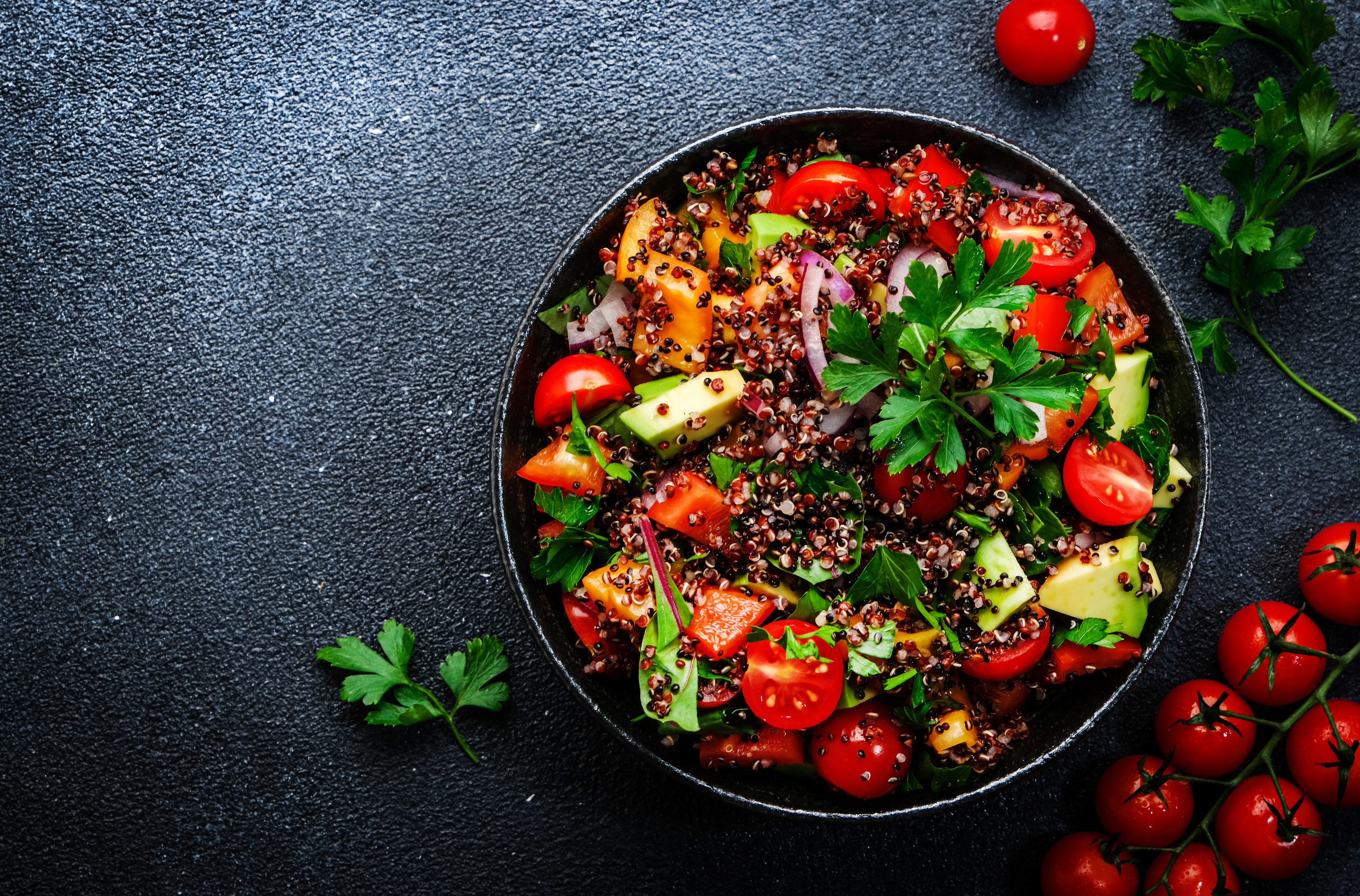 quinoa grain bowl with tomatoes and avocado