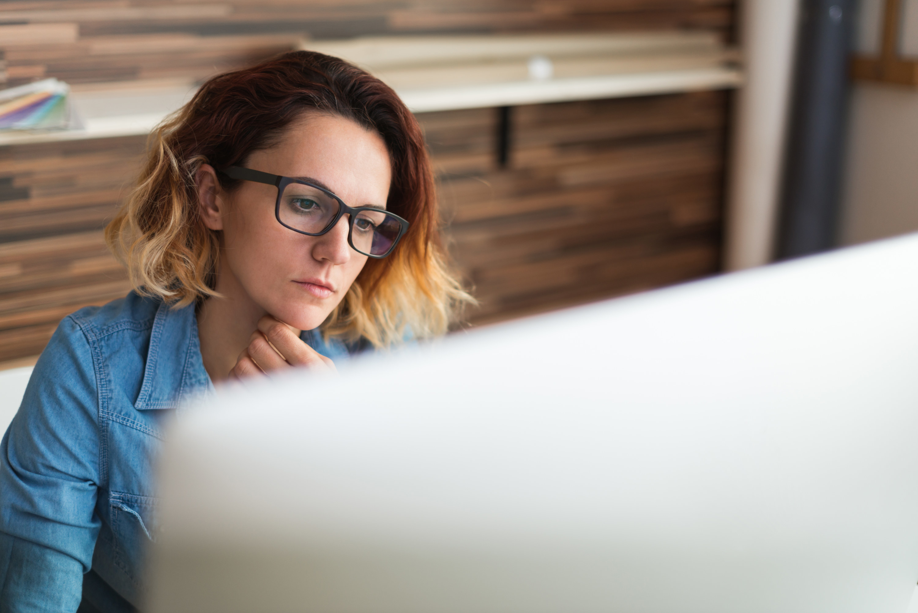 A woman works on her office computer