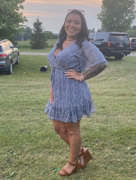 Woman wearing a blue mini dress posing outdoors